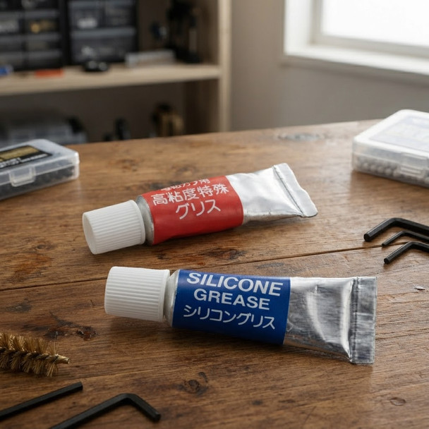 Tokyo Marui Gear and Cylinder Grease Set displayed on a wooden workbench with tools.