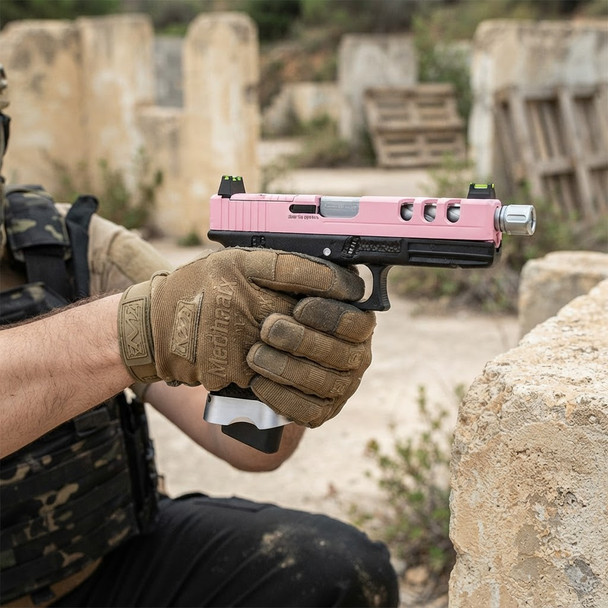 A player in tactical gloves aiming a Vorsk EU18 Vented Gas Blowback Airsoft Pistol in Pink during a game.