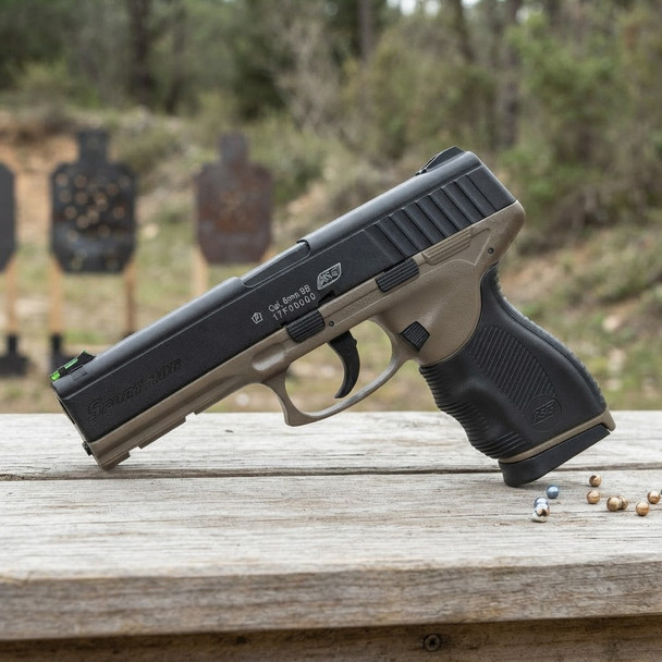 ASG Sport 106 Spring pistol in Dark Earth side view on a wooden bench with BBs and targets behind