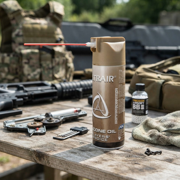 ASG - ULTRAIR Airsoft Silicone Oil Spray 220ml standing on a wooden work surface with airsoft tools and gear.