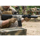 Blackviper B4812 M4 Fully Auto Airsoft Rifle in Clear held beside an equipment crate outdoors