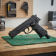 Concorde Defender Co2 Cal.50 Semi Auto Paintball Marker Airsoft Pistol in Black, left-side view on a workbench