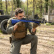 Player kneeling outdoors and aiming the AGM A160-A2 Socom M14 Spring Sniper Rifle in Blue