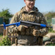 AGM STEN MKII  Full Metal Electric Airsoft Rifle in Dual Tone Blue held by a camouflaged player outdoors