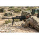 A soldier in camouflage gear prone in a field aiming the Galaxy G31 M82A1 Bolt Action Airsoft Sniper Rifle.