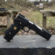 WE Tech Dragon 7.0 Type-B Government model Gas Blowback Airsoft Pistol in Black in side view on an outdoor bench