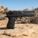 Cybergun Magnum Research Inc. Desert Eagle 50AE GBB Pistol Black, right side view on a desert rock