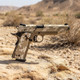 Raven M1911 MEU GBB Airsoft Pistol in Digital Desert resting on a rock in a desert environment.