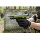 First-person perspective of the Vorsk EU18 Gas Blowback Airsoft Pistol in Black with Green Top Slide firing in a woodland.