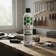 ASG ULTRAIR Power Airsoft Gas with Silicone 570 ml 135Psi (Green) standing on a workbench with tools and airsoft gear.