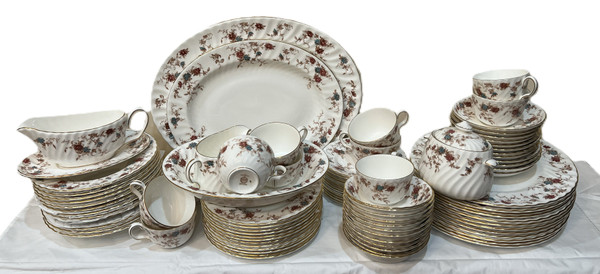 This is a large collection of Minton "Ancestral" bone china dinnerware. The pattern features a rust and teal floral design with scalloped edges and gold trim.