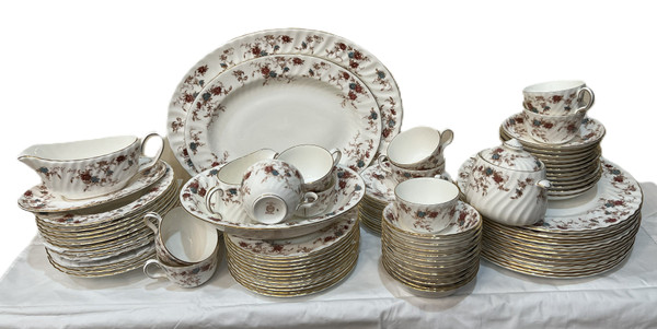 This is a large collection of Minton "Ancestral" bone china dinnerware. The pattern features a rust and teal floral design with scalloped edges and gold trim.