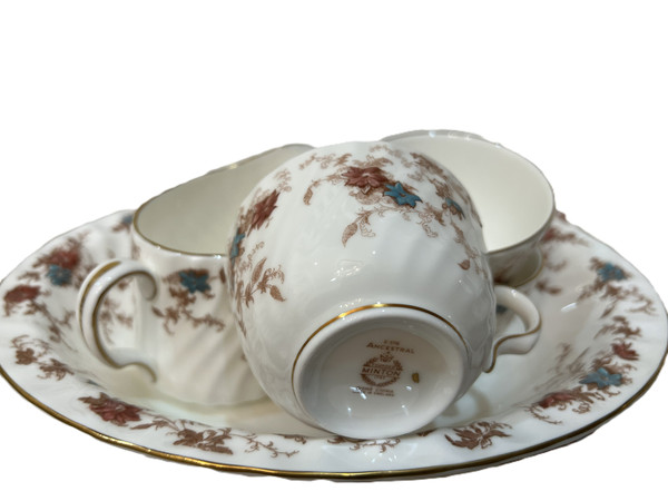 This is a large collection of Minton "Ancestral" bone china dinnerware. The pattern features a rust and teal floral design with scalloped edges and gold trim.