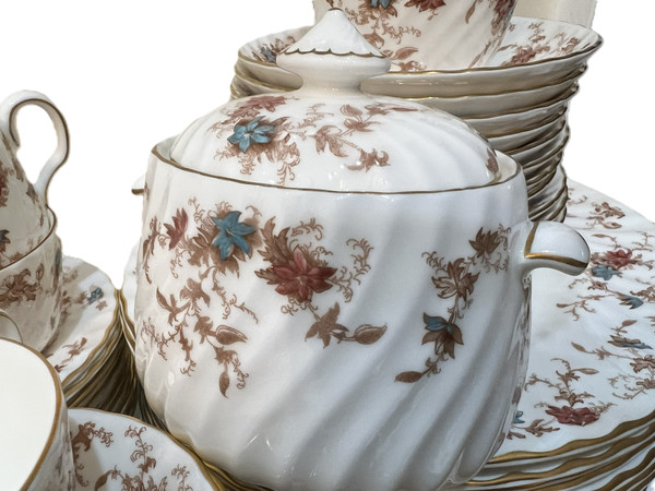 This is a large collection of Minton "Ancestral" bone china dinnerware. The pattern features a rust and teal floral design with scalloped edges and gold trim.