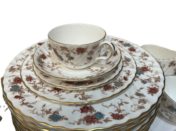 This is a large collection of Minton "Ancestral" bone china dinnerware. The pattern features a rust and teal floral design with scalloped edges and gold trim.