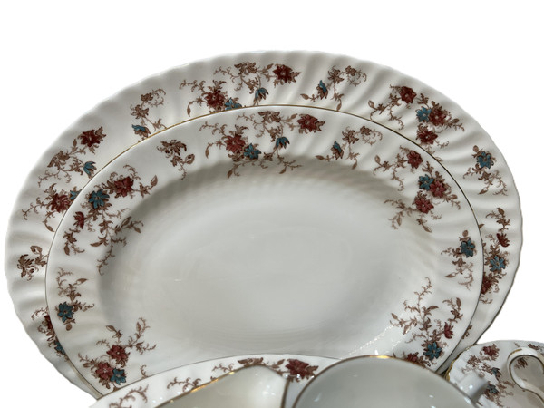 This is a large collection of Minton "Ancestral" bone china dinnerware. The pattern features a rust and teal floral design with scalloped edges and gold trim.