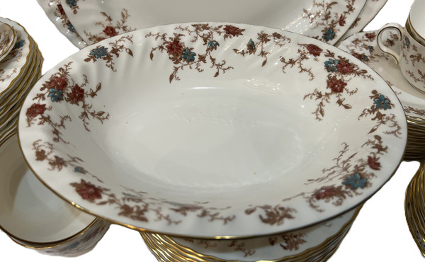 This is a large collection of Minton "Ancestral" bone china dinnerware. The pattern features a rust and teal floral design with scalloped edges and gold trim.
