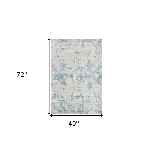 4' X 6' Ivory And Sky Blue Abstract Area Rug