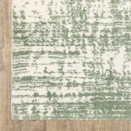 5' X 8' Green And Ivory Abstract Area Rug