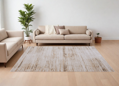 7' X 10' Ivory and Tan Abstract Power Loom Worn Faded Area Rug