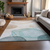 10' X 14' Beige Ivory And Teal Abstract Washable Area Rug With UV Protection