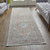 8' Gray Ivory and Orange Oriental Power Loom Worn Faded Runner Rug With Fringe