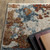 7' X 10' Beige Rust And Teal Abstract Distressed Area Rug With Fringe