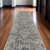 10' Ivory and Gray Abstract Power Loom Worn Faded Runner Rug With Fringe