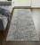 10' Ivory and Gray Abstract Power Loom Worn Faded Runner Rug With Fringe