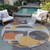 8' Gray Gold And Orange Round Geometric Washable Indoor Outdoor Area Rug