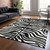 9' X 12' Black And Ivory Animal Print Washable Indoor Outdoor Area Rug