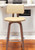 26" Cream And Wood Brown Faux Leather Swivel Low Back Counter Height Bar Chair