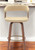 26" Cream And Wood Brown Faux Leather Swivel Counter Height Bar Chair