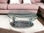 30" Clear And Silver Glass And Metal Oval Abstract Coffee Table