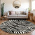 8' Black And Ivory Round Animal Print Washable Indoor Outdoor Area Rug