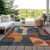 9' X 12' Navy Blue And Orange Abstract Washable Indoor Outdoor Area Rug
