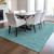 5' X 8' Teal Blue Black And Ivory Geometric Washable Indoor Outdoor Area Rug