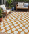 5' X 8' Orange And Ivory Polka Dot Washable Indoor Outdoor Area Rug