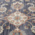 5' X 8' Ivory Orange And Dark Gray Floral Area Rug