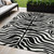 5' X 8' Black And Ivory Animal Print Washable Indoor Outdoor Area Rug