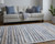 Homeroots Home Decor 8' x 10' Ivory Blue and Orange Striped Power Loom Stain Resistant Area Rug