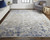 Homeroots Home Decor 5' x 8' Tan Ivory and Blue Abstract Power Loom Distressed Area Rug