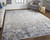 Homeroots Home Decor 5' x 8' Tan Ivory and Blue Abstract Power Loom Distressed Area Rug