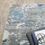 Homeroots Home Decor 6' x 9' Abstract Power Loom Stain Resistant Area Rug, Grey Blue Ivory Navy Beige and Brown