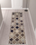 10' Ivory Brown And Black Quatrefoil Distressed Runner Rug