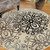 Homeroots Home Decor 8' Round Floral Medallion Area Rug, Tan Gray and Black, Stain Resistant