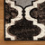 10' Brown Black And Ivory Quatrefoil Distressed Runner Rug