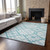 10' X 14' Teal And Ivory Geometric Washable Area Rug With UV Protection