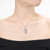 Collette Z Sterling Silver with Rhodium Plated Clear Round Cubic Zirconia Swirl Oval Pendant Necklace