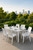 Seven Piece White Plastic Outdoor Patio Set With Table